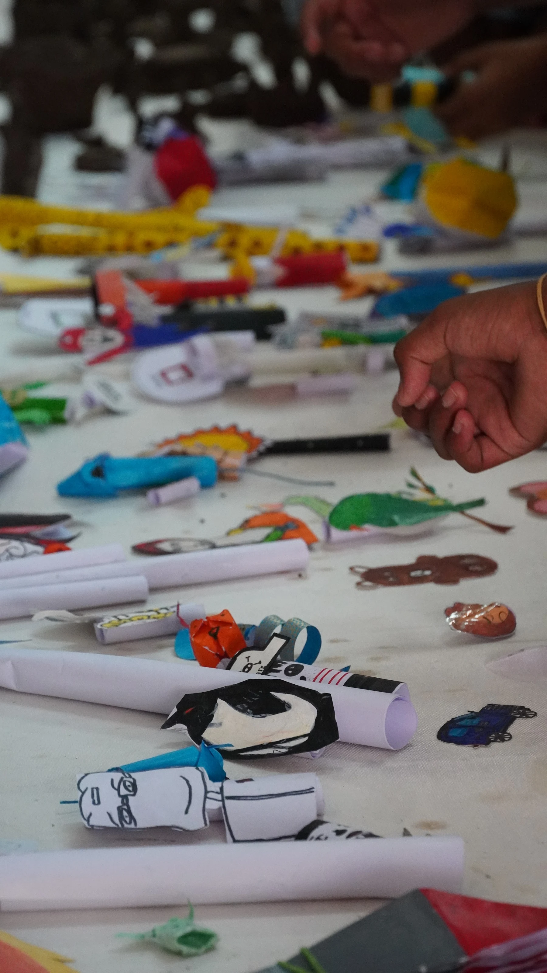 Close view of a table covered with folded and cut paper pieces