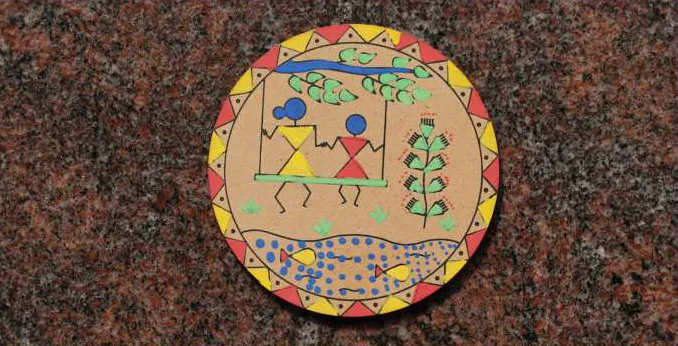 Photograph of a painted round disc with folk figures, laid on stone