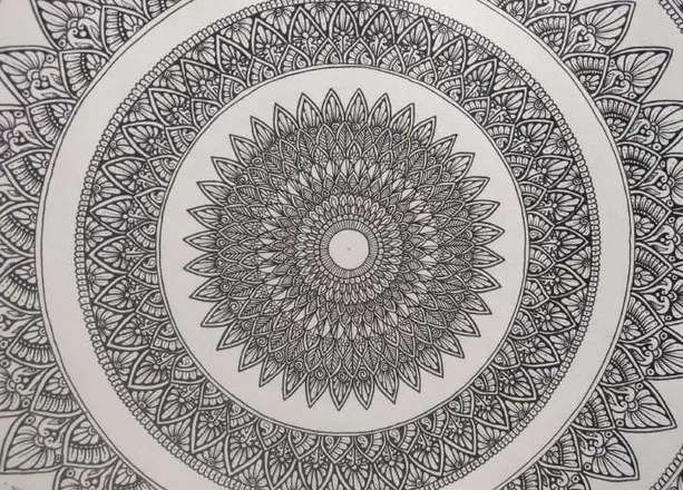 A large round mandala in fine black pattern