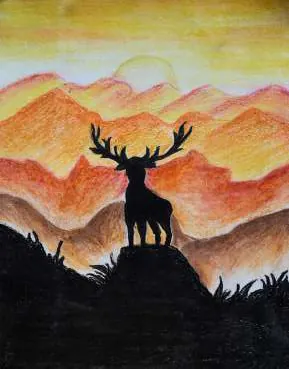 A stag silhouetted on a hilltop against orange mountains at sunset