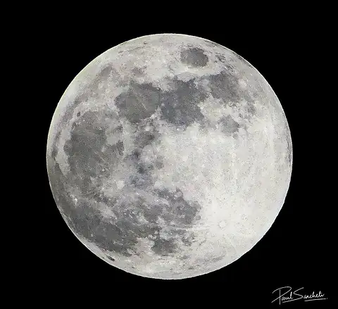 A bright full moon against a black sky