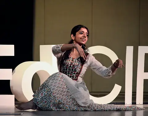A performer seated on stage