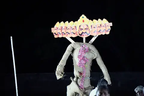 The ten-headed Ravan effigy standing on the dark field before it is lit