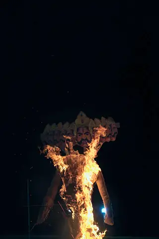 The Ravan effigy burning in the distance against a black sky