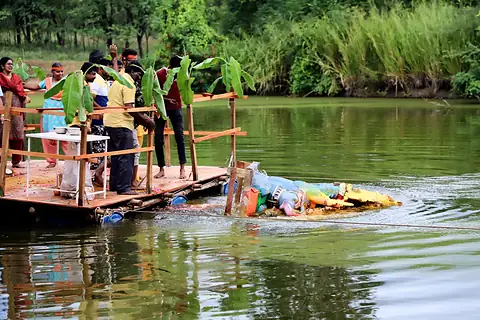 The murti being lowered from the raft into the lake