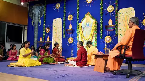Students seated before the altar at the Krishna Pooja on Diwali morning
