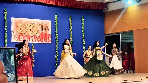 A junior house dance team mid-performance at the Inter-House Group Dance Competition