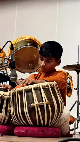 A student playing tabla at the Inter-House Solo Instrumental Competition
