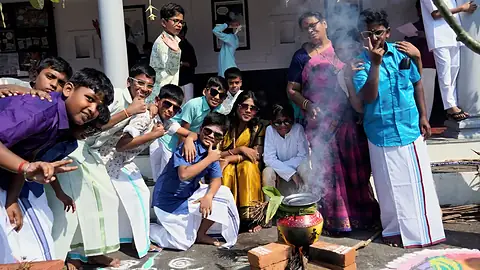 Students in traditional attire preparing Pongal on campus