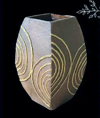 A brown vase with raised gold swirls
The Crossroads, Issue 10 · August 2023