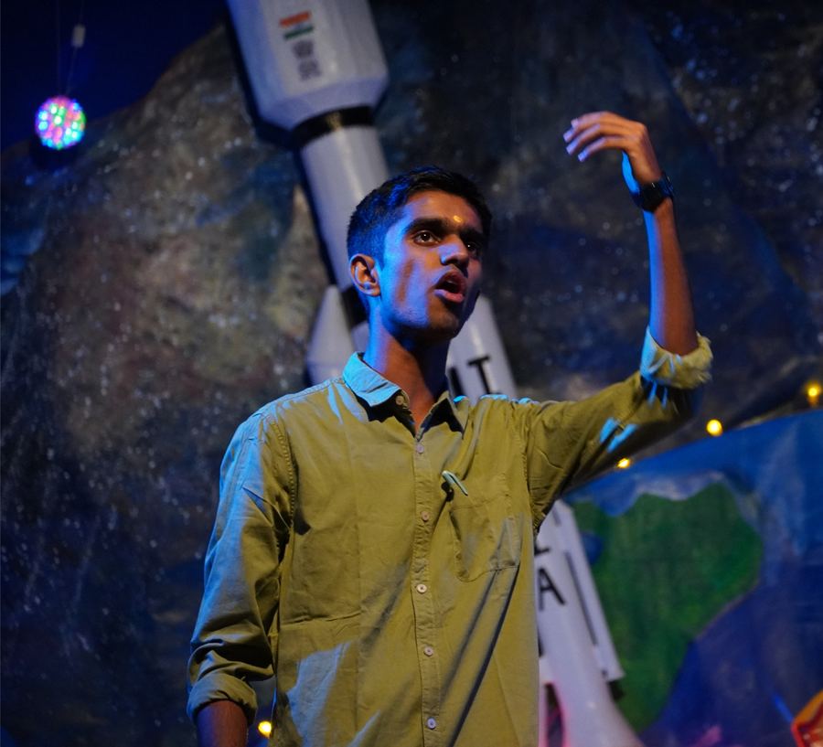 A performer under blue stage lights
