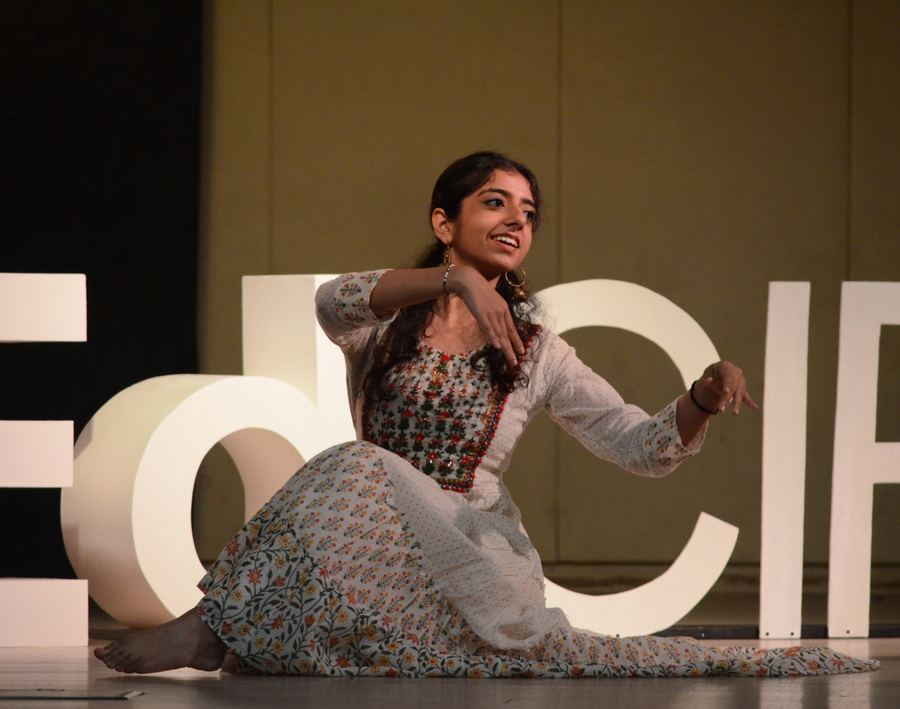 A performer seated on stage