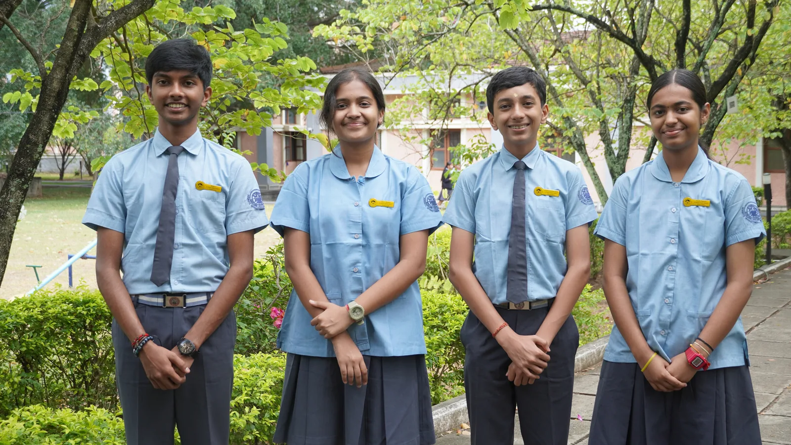 The four Valmiki House Captains of the Student Council 2026–27 standing in a row beside a lake