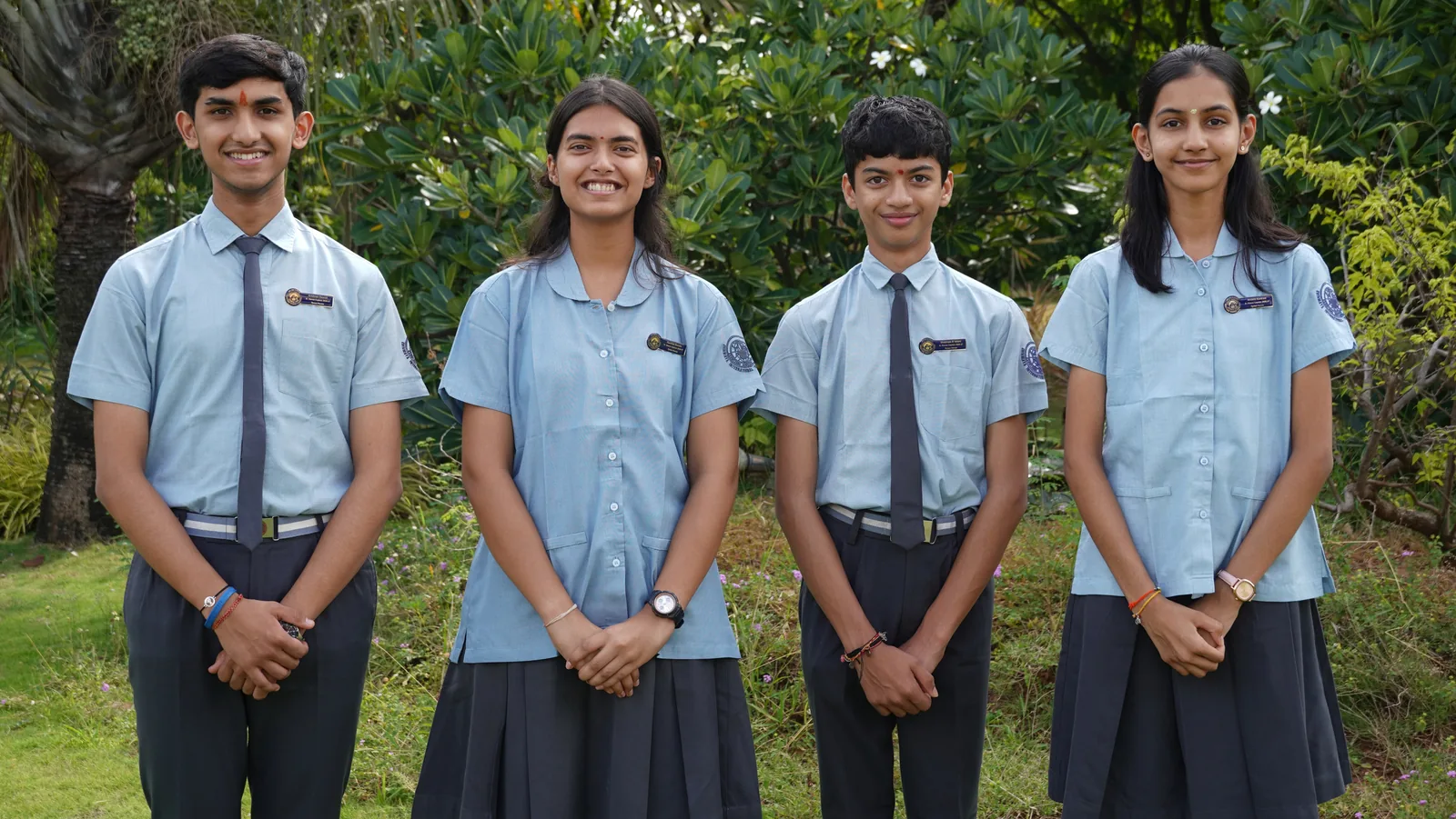 The four Vyasa House Captains of the Student Council 2026–27 standing in a row before green shrubs