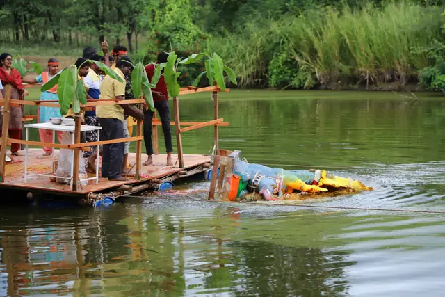 The murti being lowered from the raft into the lake
