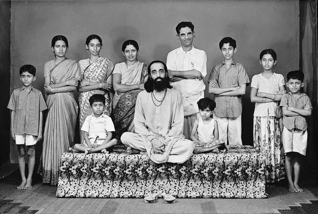 A posed group with adults and children.