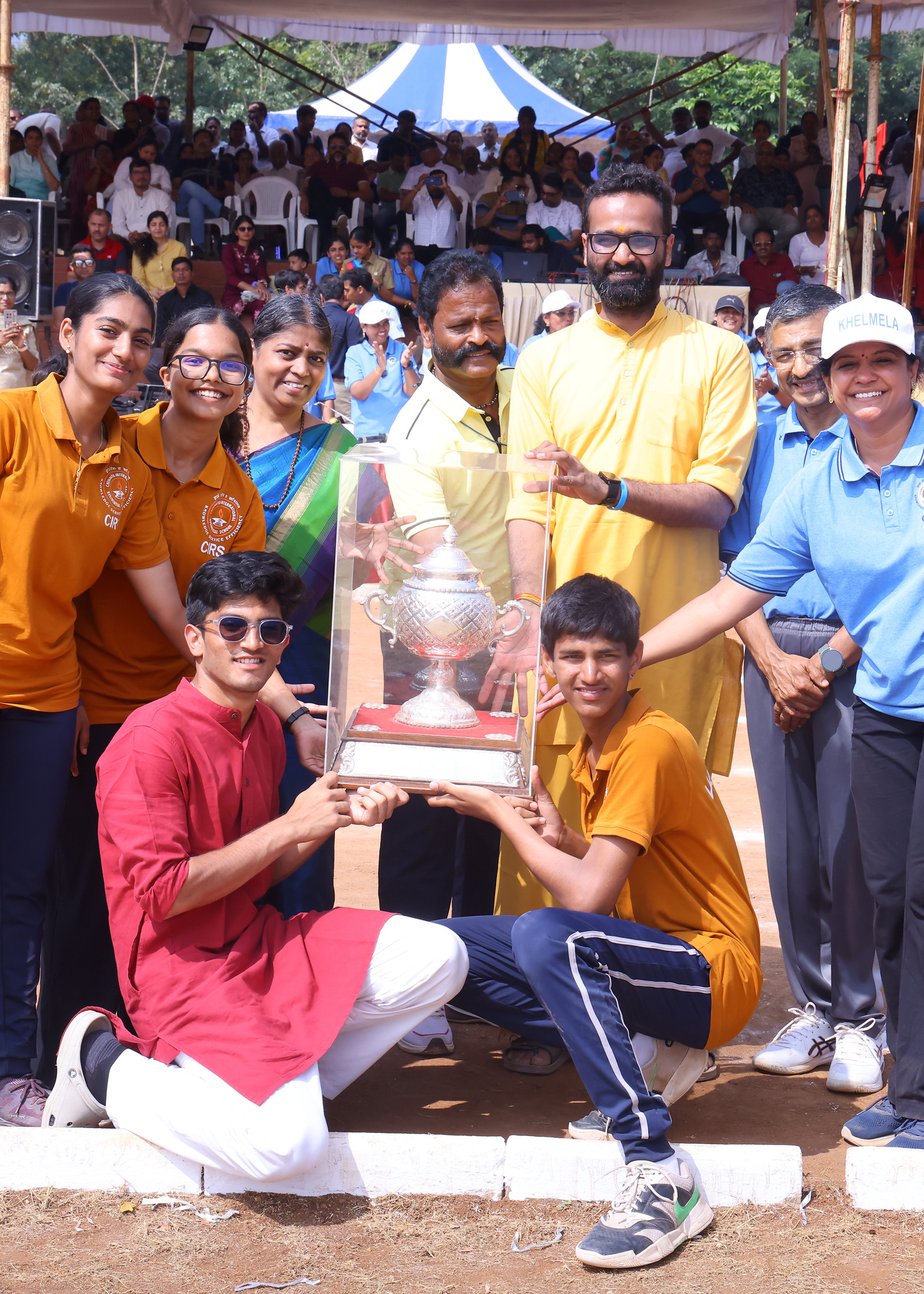 Valmiki students and staff receiving a trophy