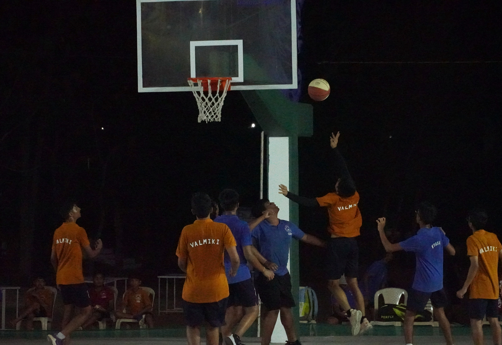 Valmiki players in named yellow shirts competing in an inter-house basketball game