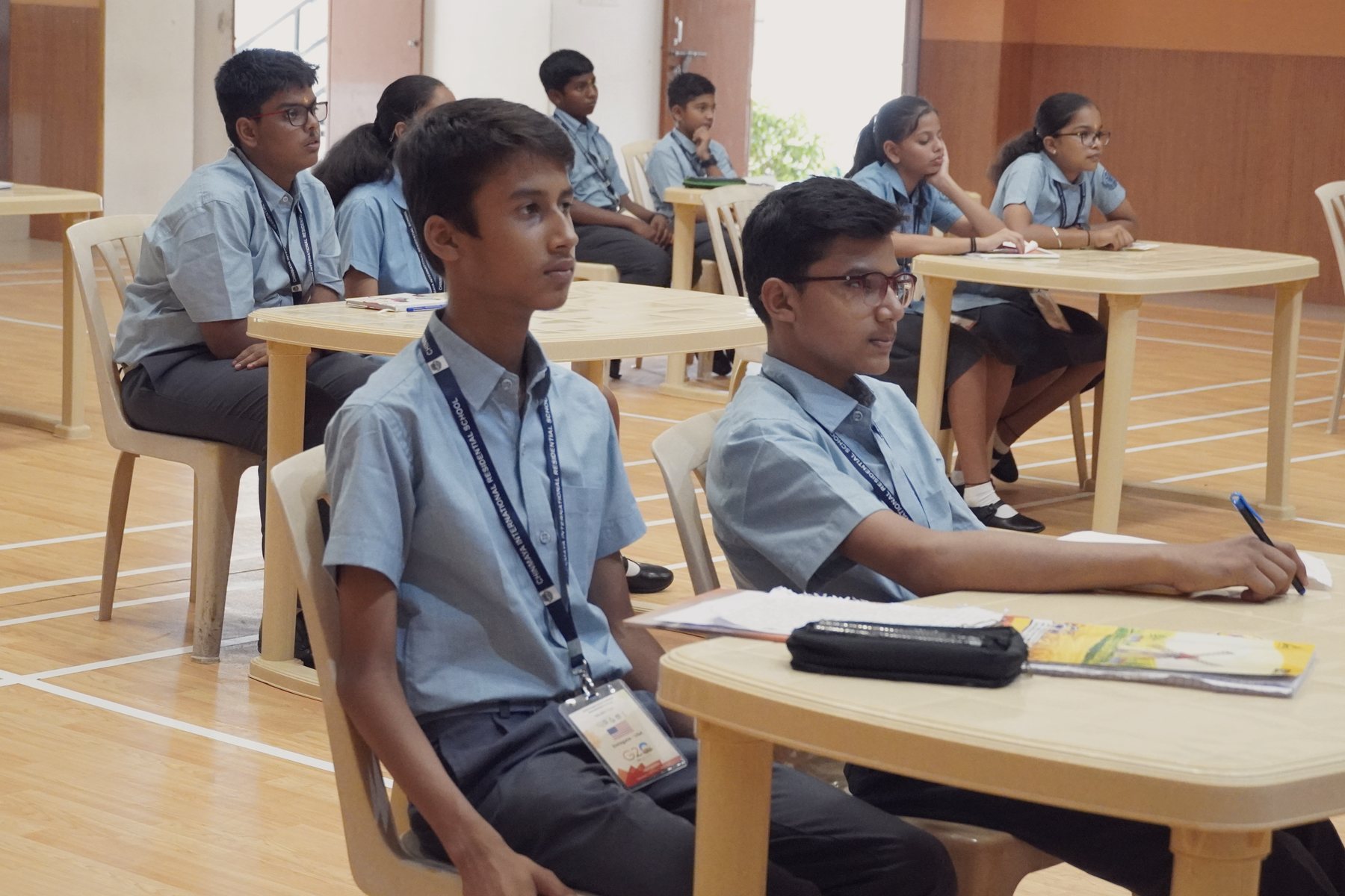 CIRS students at their desks during an examination, one looking up