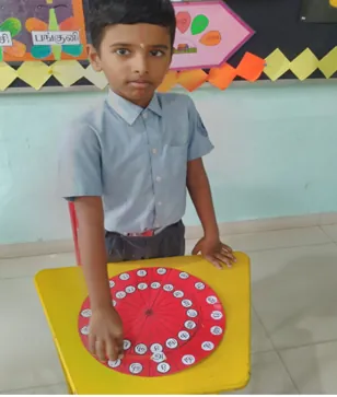 A Class 1 student using a Tamil language wheel