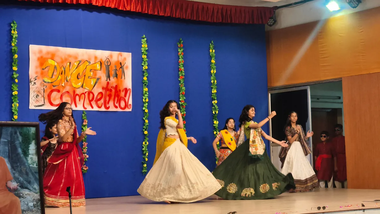 A junior house dance team mid-performance at the Inter-House Group Dance Competition