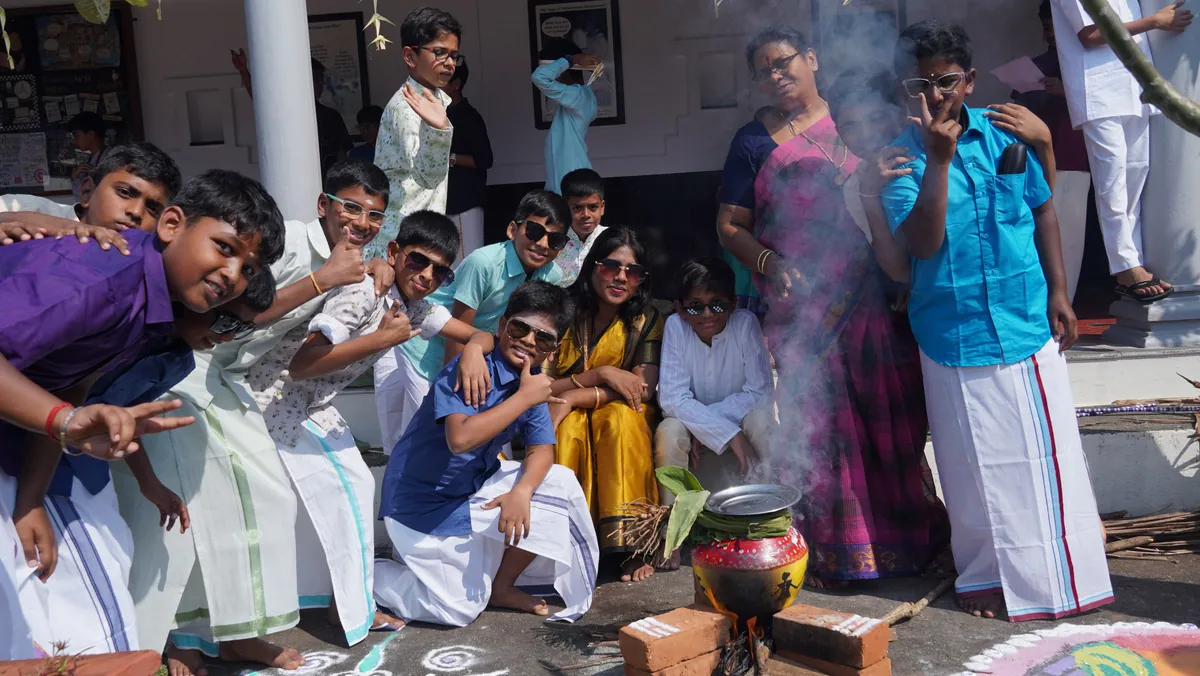 Students in traditional attire preparing Pongal on campus