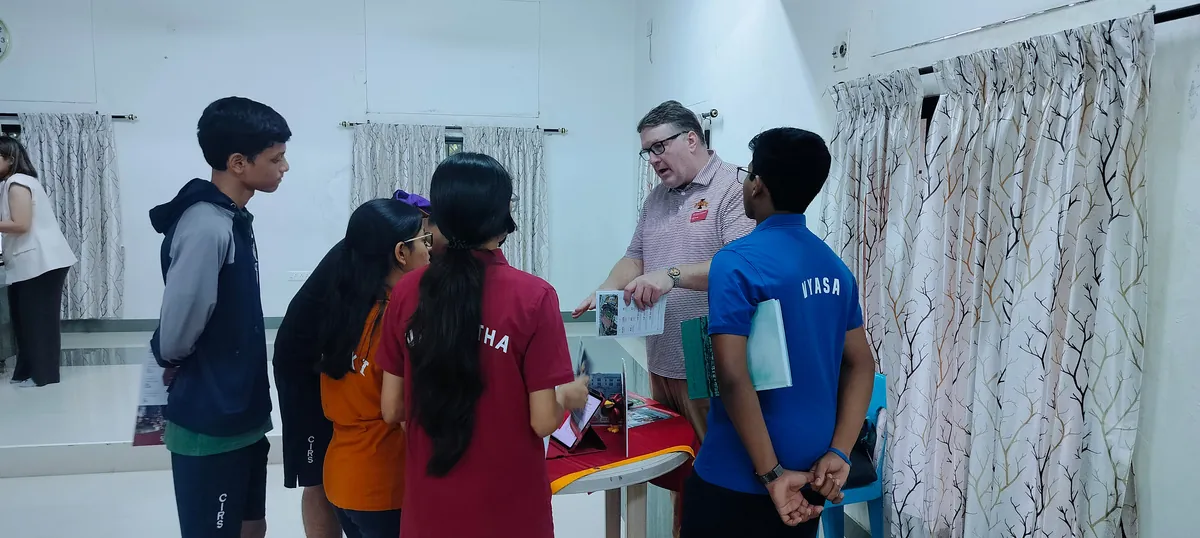 CIRS students speaking with a university representative at the University Fair