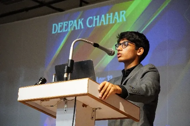 A student at the podium during the YEI IPL Auction simulation