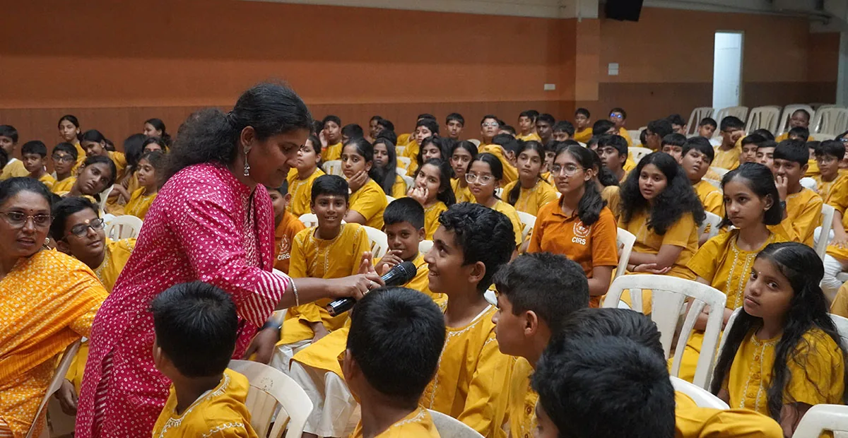 A CIRS student speaking during an English Week activity while classmates listen