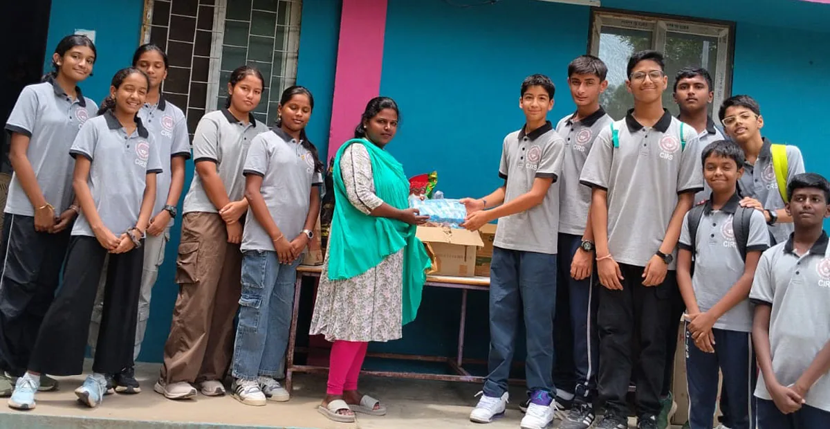 CIRS students handing supplies to a community member during Seva Week