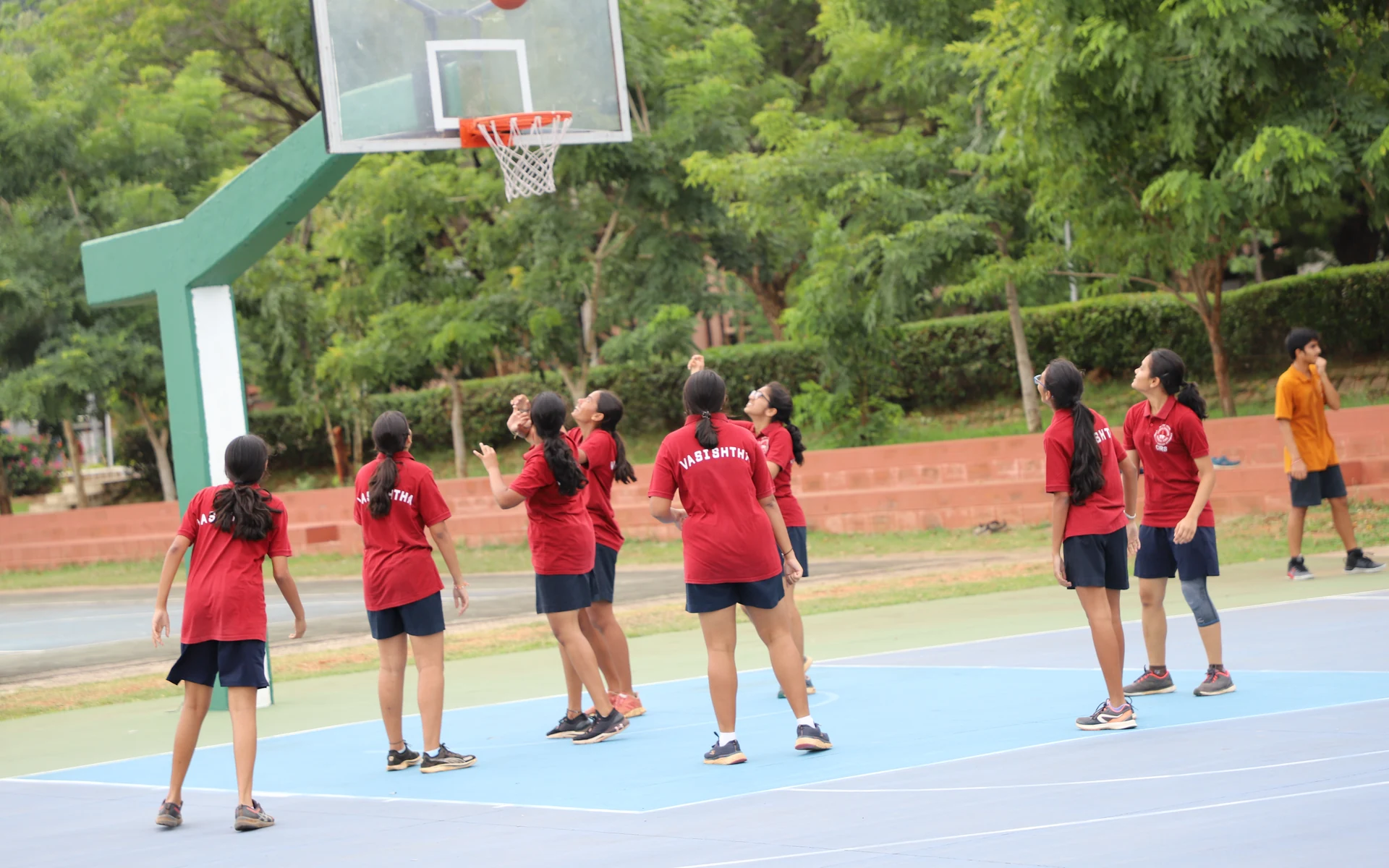 CIRS students follow the play on the outdoor basketball court