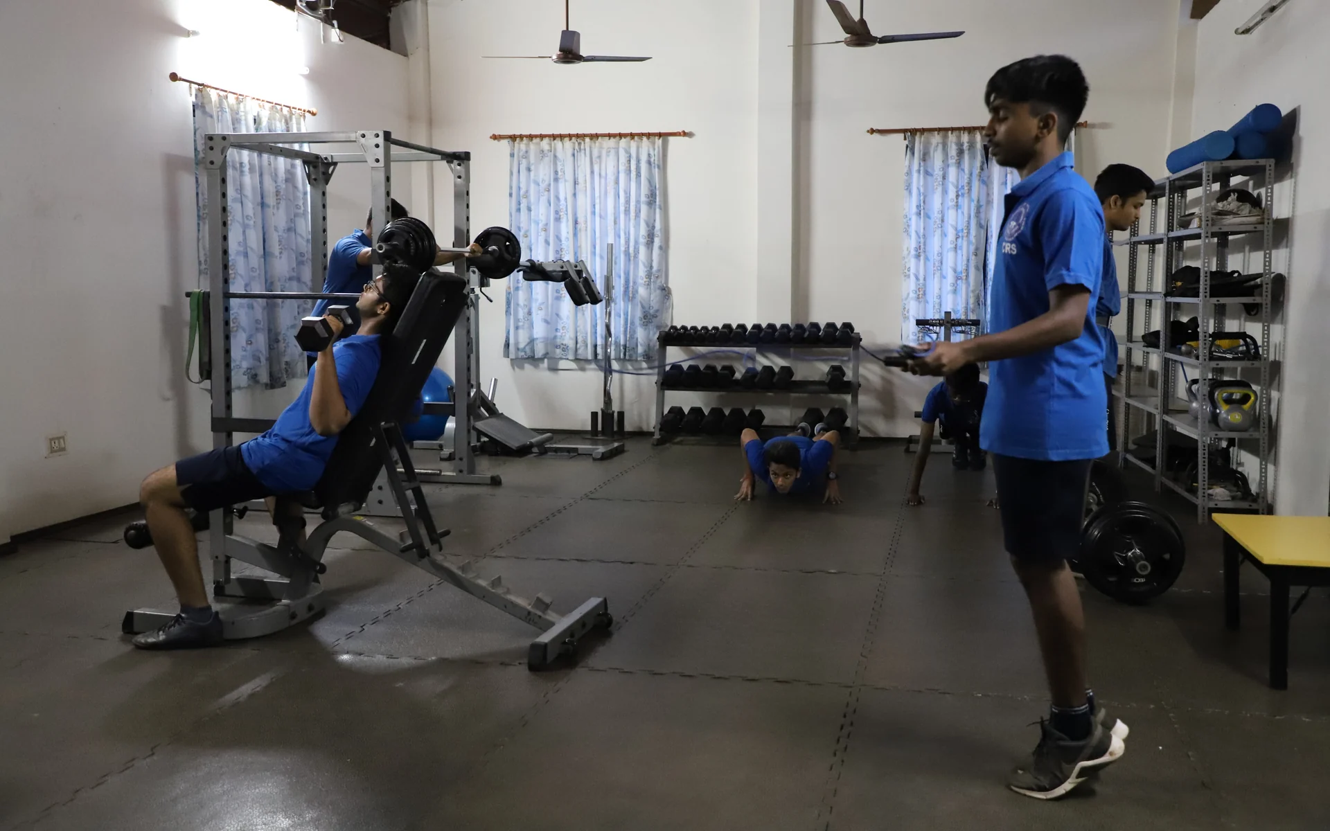 CIRS students work with weights in the school gym