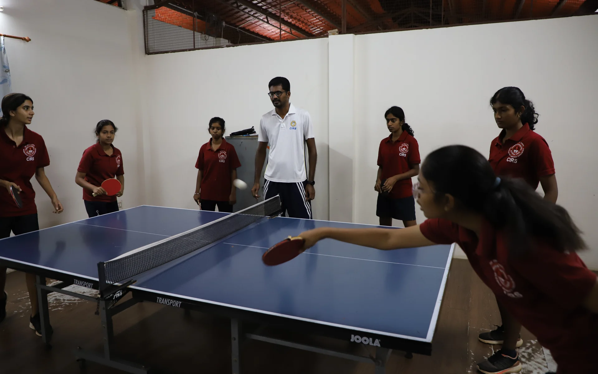 A CIRS student reaches into a table tennis rally