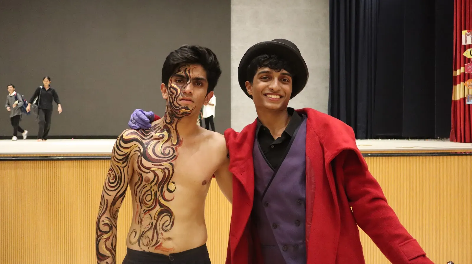 Two Valmiki performers after Melora, one in body paint and one in a red coat